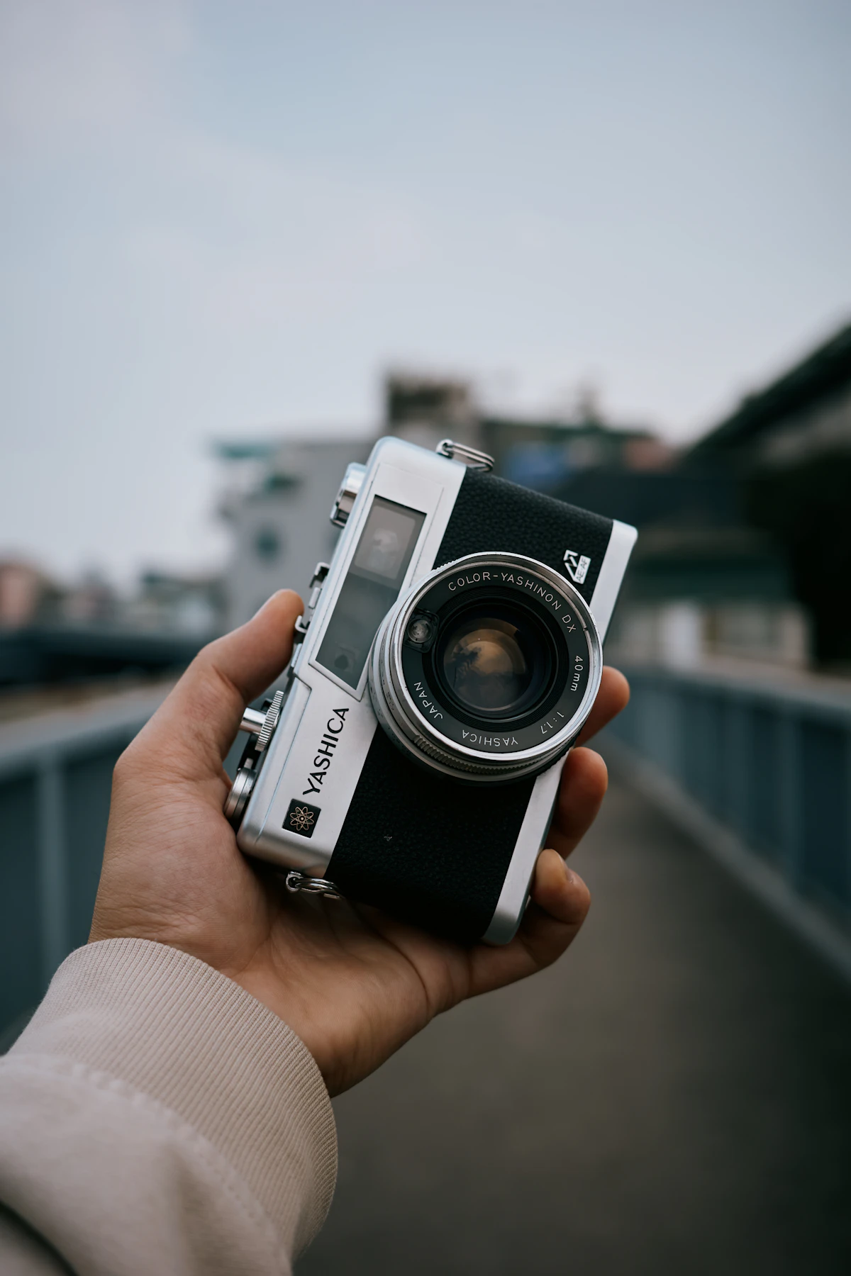 Hand holding a vintage compact film camera
