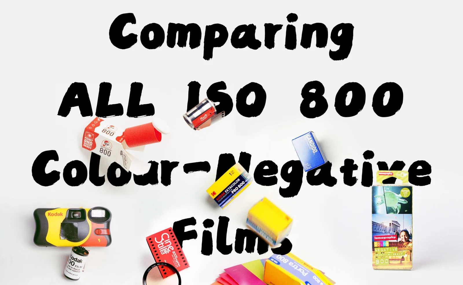Boxes and cassettes of eight ISO 800 color-negative films, including Kodak Ektacolor Pro 800, CineStill 800T, Candido 800, and Lomography Color Negative 800, scattered on a white surface