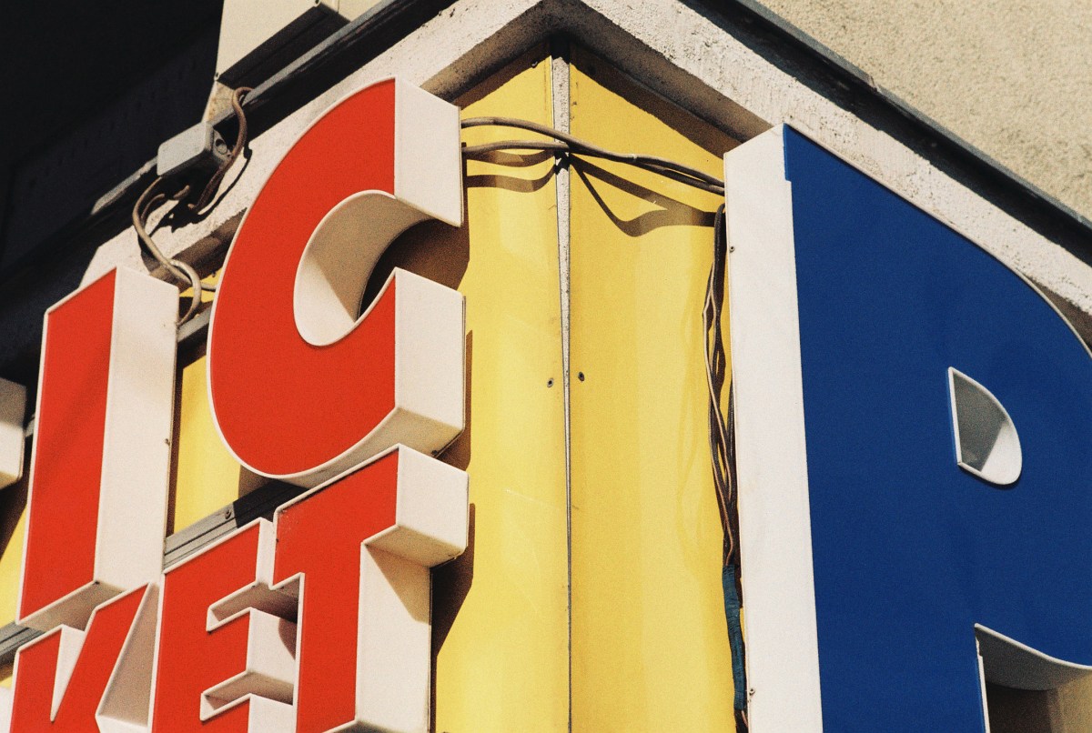 Shop sign photographed on LomoChrome Classicolor showing warm amber tones