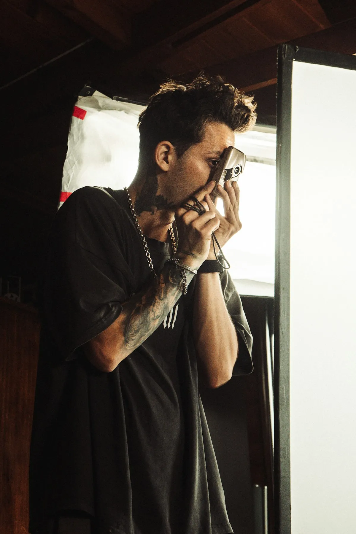 Photographer holding a vintage film camera up to his eye